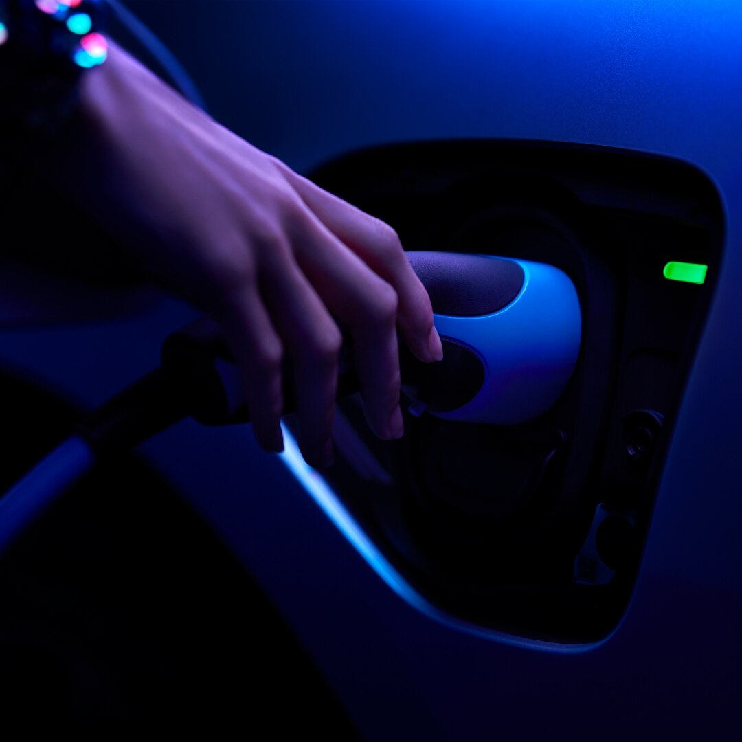Blue IPACE image close up of hand charging car